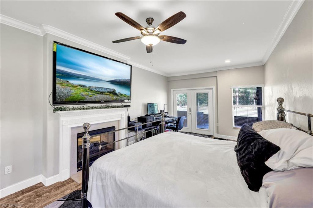 2875 Garland Road Naples, FL 34117 - Photo 13 of 34 a bed room with furniture and a flat screen tv