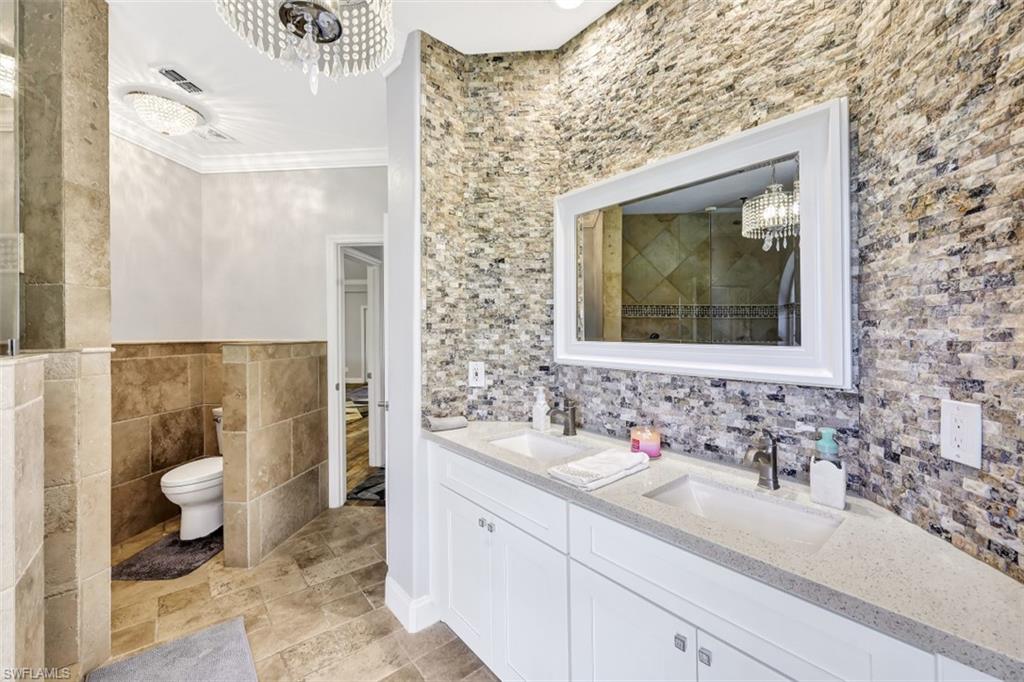 2875 Garland Road Naples, FL 34117 - Photo 14 of 34 a bathroom with a sink and a mirror