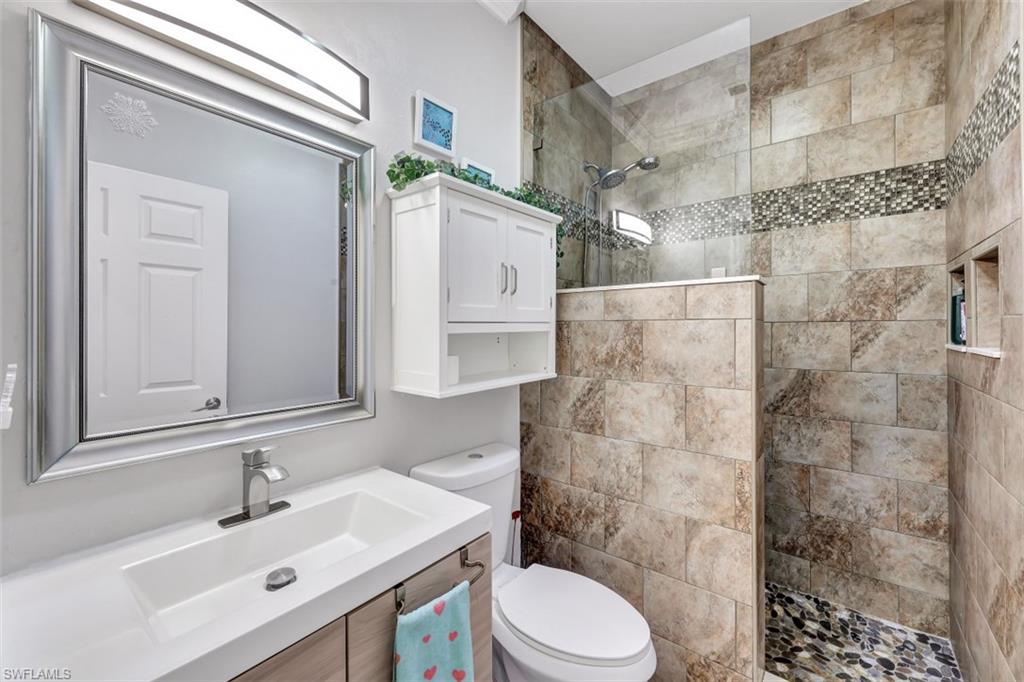 2875 Garland Road Naples, FL 34117 - Photo 17 of 34 a bathroom with a sink toilet and shower