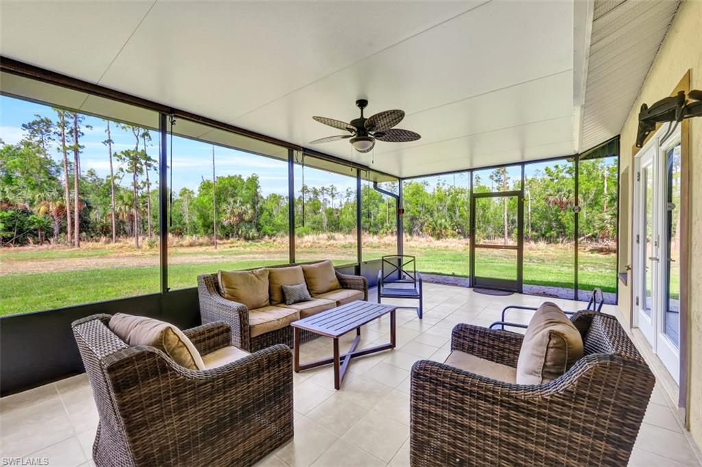 2875 Garland Road Naples, FL 34117 - Photo 21 of 34 a living room with furniture and a floor to ceiling window