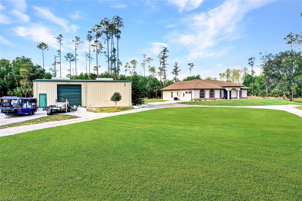 2875 Garland Road Naples, FL 34117 - Photo 22 of 34 a view of a house with a garden