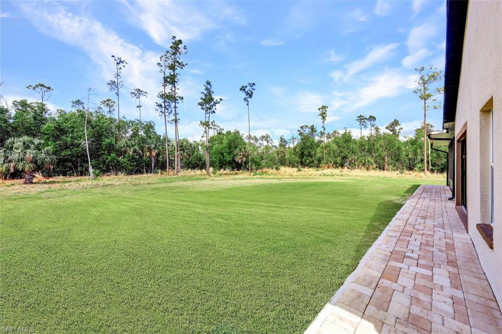 2875 Garland Road Naples, FL 34117 - Photo 24 of 34 a view of a golf course with a garden