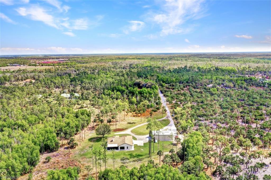 2875 Garland Road Naples, FL 34117 - Photo 28 of 34 an aerial view of residential houses with outdoor space and trees