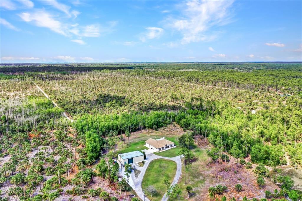 2875 Garland Road Naples, FL 34117 - Photo 3 of 34 a view of a lake with houses in the back