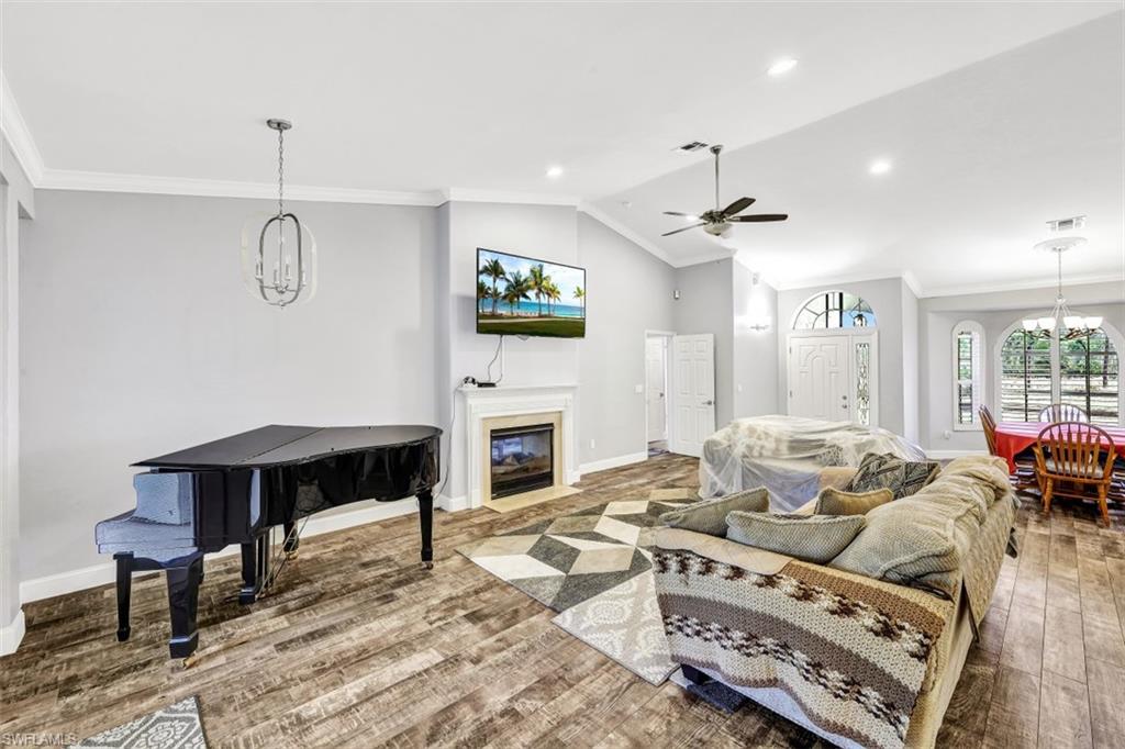 2875 Garland Road Naples, FL 34117 - Photo 5 of 34 a living room with furniture a fireplace and a flat screen tv