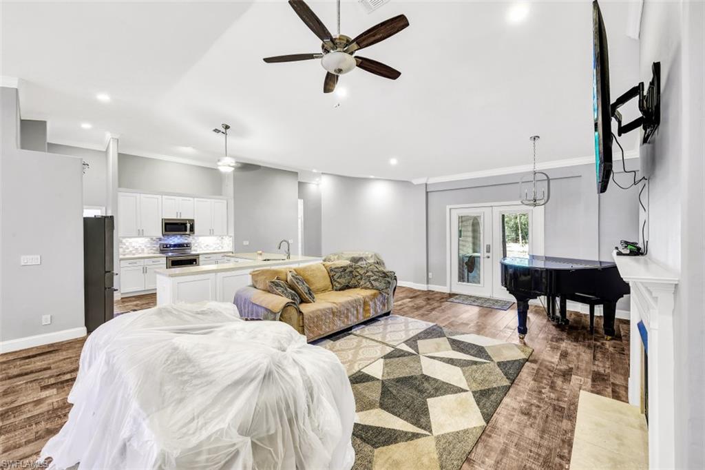 2875 Garland Road Naples, FL 34117 - Photo 6 of 34 a large white kitchen with a dining table and chairs