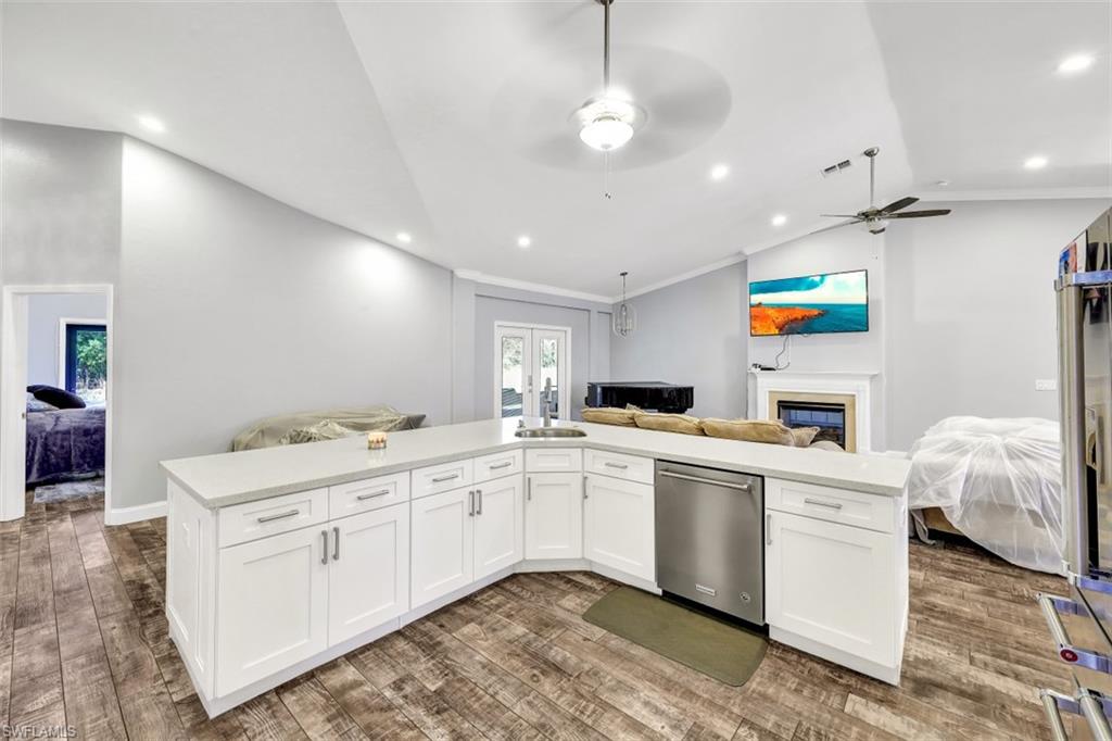 2875 Garland Road Naples, FL 34117 - Photo 7 of 34 a kitchen with white cabinets and sink