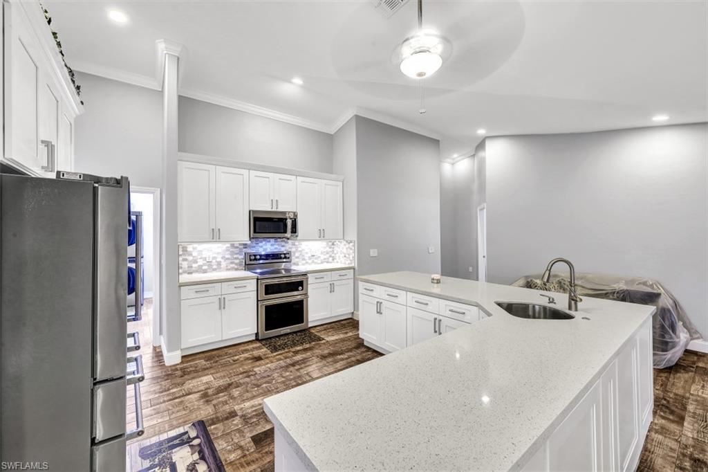 2875 Garland Road Naples, FL 34117 - Photo 8 of 34 a kitchen with a sink appliances and cabinets