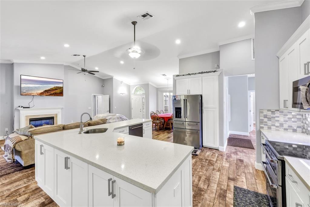 2875 Garland Road Naples, FL 34117 - Photo 9 of 34 a view of a kitchen area kitchen island and stainless steel appliances