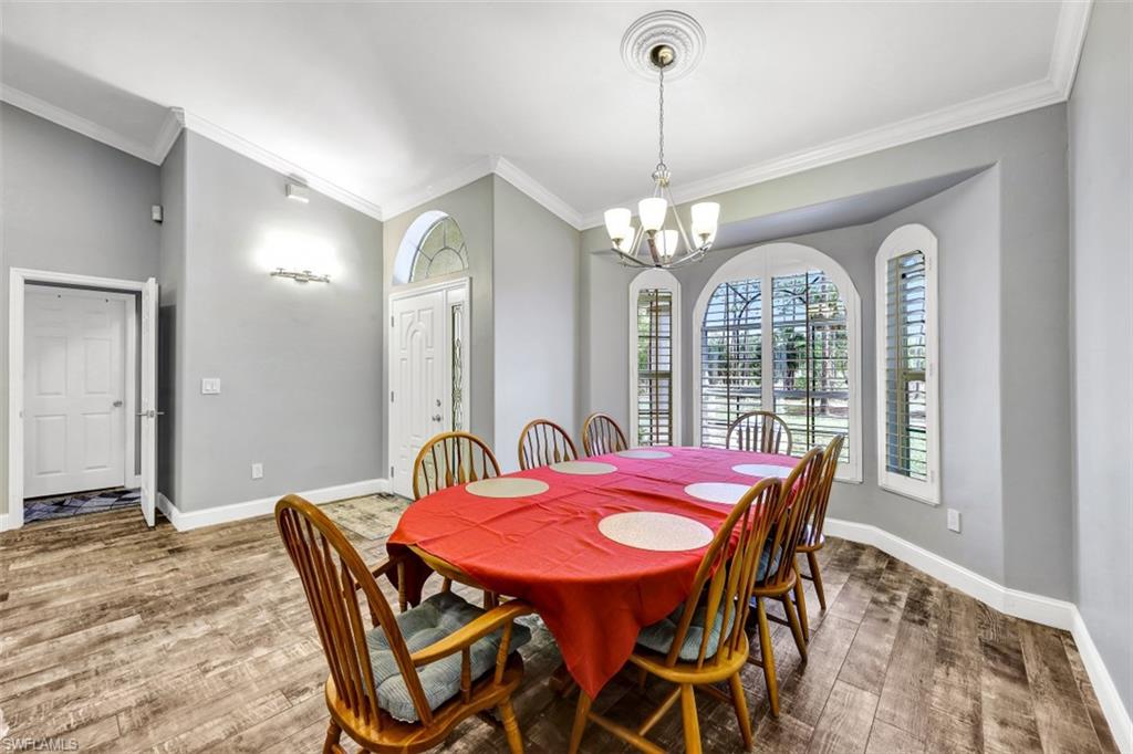 2875 Garland Road Naples, FL 34117 - Photo 10 of 34 a view of a dining room with furniture window and wooden floor