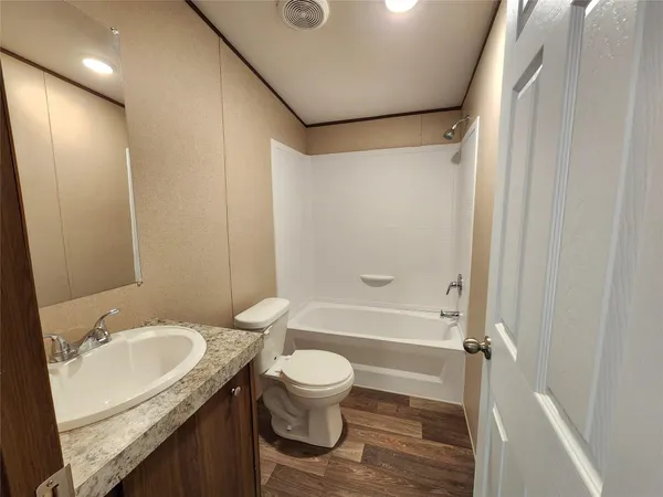 a bathroom with a bathtub and a toilet
