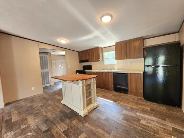 a large room with a lot of cabinets and wooden floor