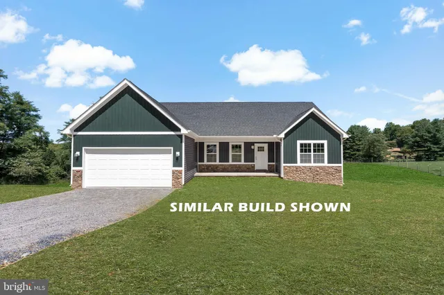 a view of a back yard of the house with a street