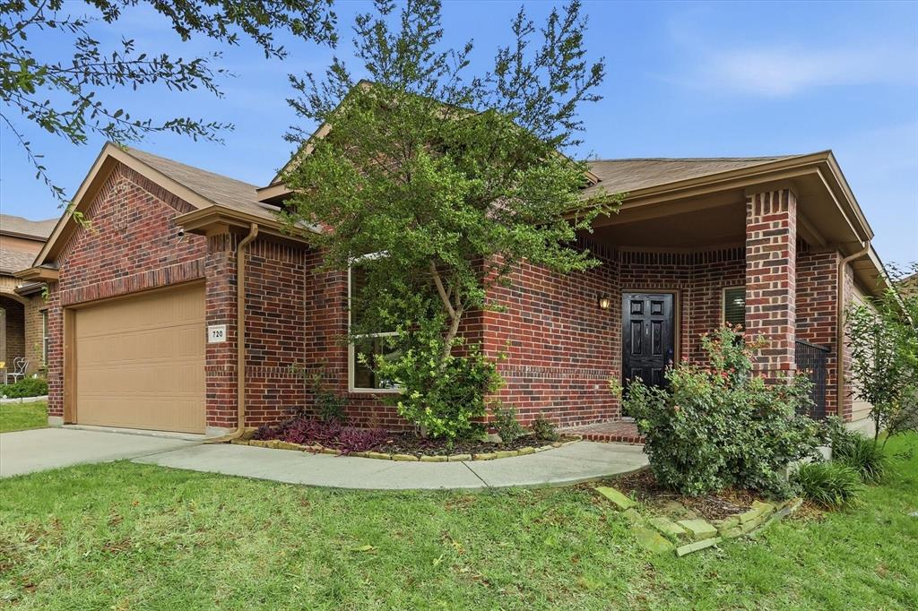 720 Rio Bravo Drive Fort Worth, TX 76052 - Photo 4 of 38 Brick exterior featuring a covered entry, an integrated single-car garage, and a front yard with established landscaping