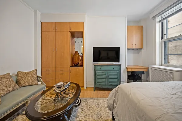 a bedroom with a bed and a television
