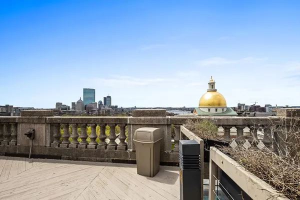 a view of a roof deck with wooden floor and barbeque oven