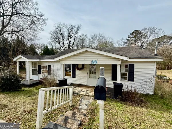 a front view of house with yard seating and green space