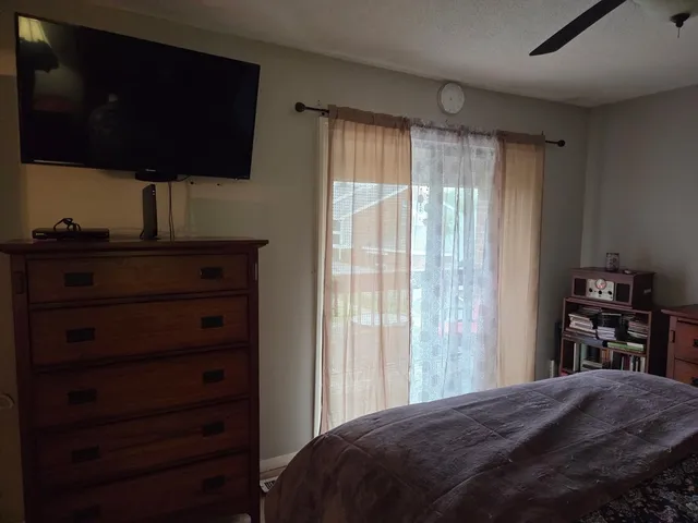 a bedroom with a bed and a television