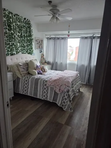 a bedroom with a bed lamp and a window