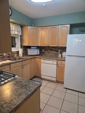 a kitchen with a sink appliances and cabinets