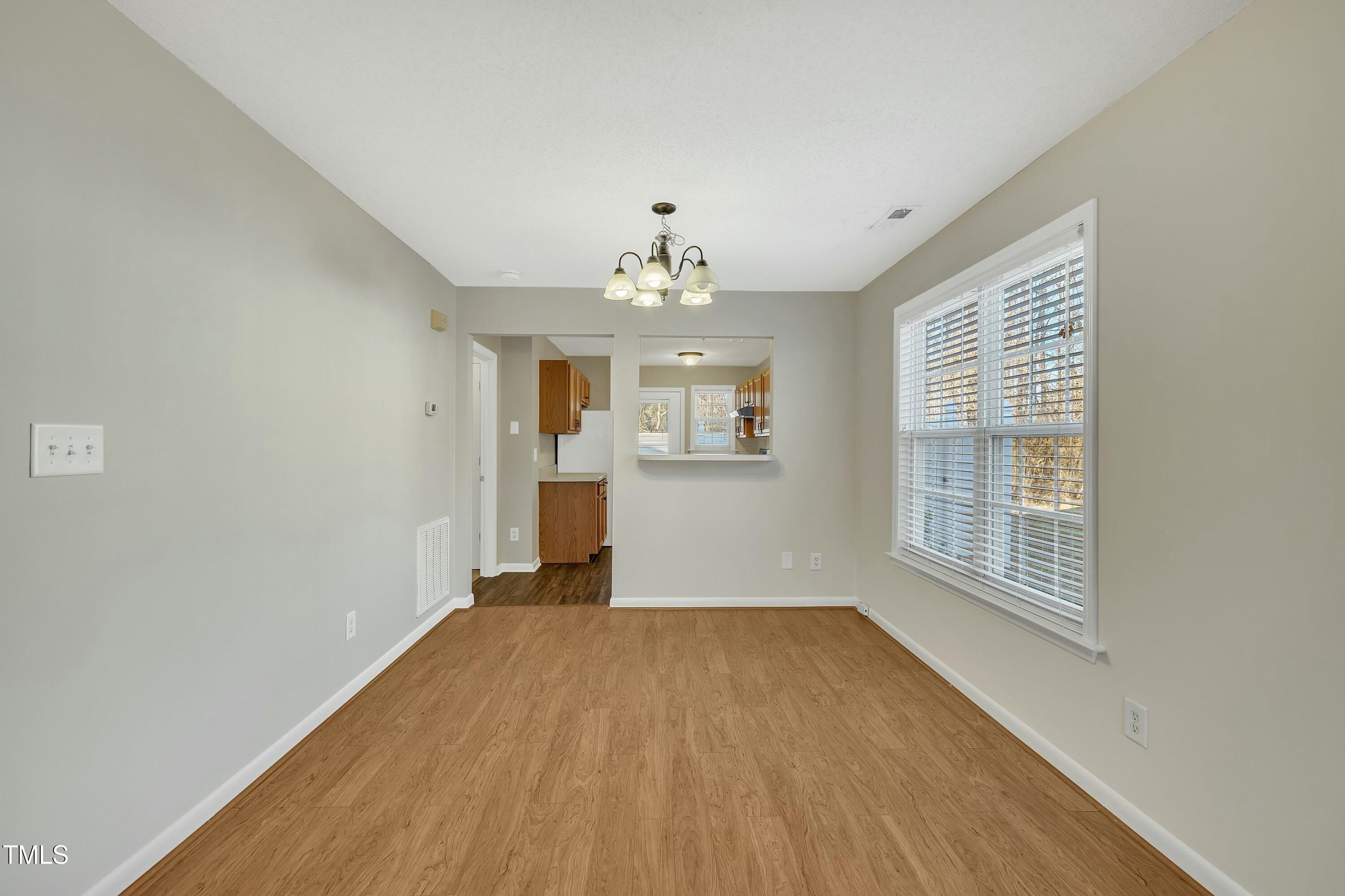 3727 Votive Lane Raleigh, NC 27604 - Photo 9 of 28 Dining area attached to Living/Family Room with window poke out to look into Kitchen.