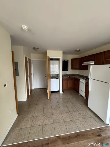 a view of a kitchen with refrigerator and dishwasher