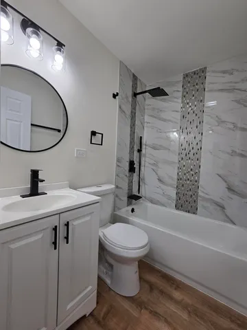 a bathroom with a sink toilet and shower