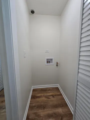 a view of a room with wooden floor