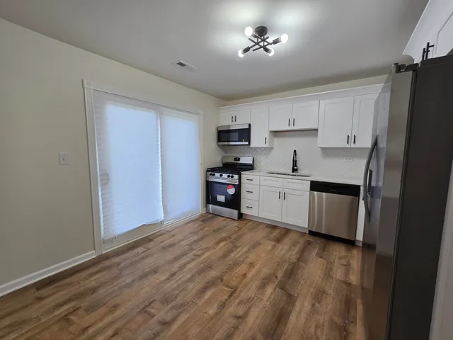 a view of a kitchen with electric appliances