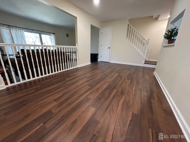 a view of a hallway view with wooden floor and staircase