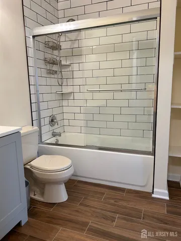 a bathroom with a toilet and a shower