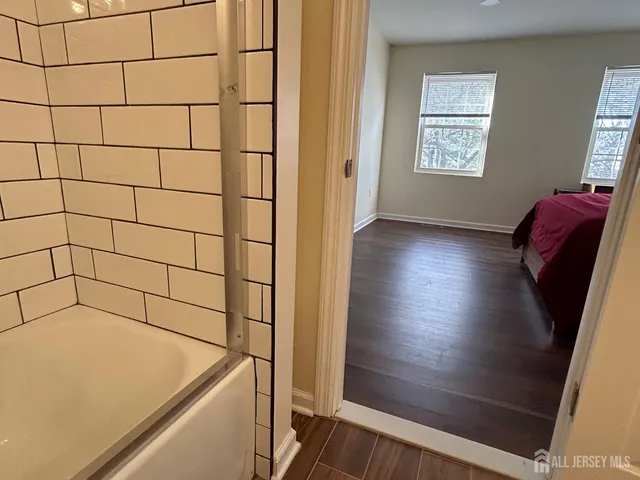 a bathroom with a tub and shower