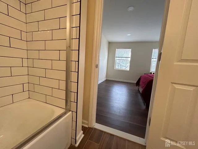 a spacious bedroom with a bed and a window