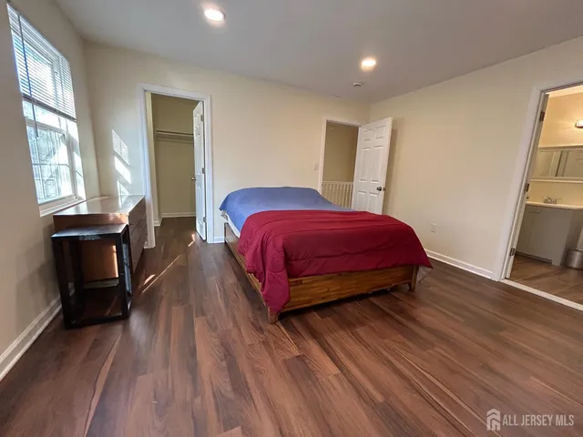 a kitchen with wooden floor and a window