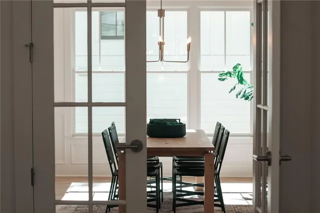 a view of a room with wooden floor and a potted plant