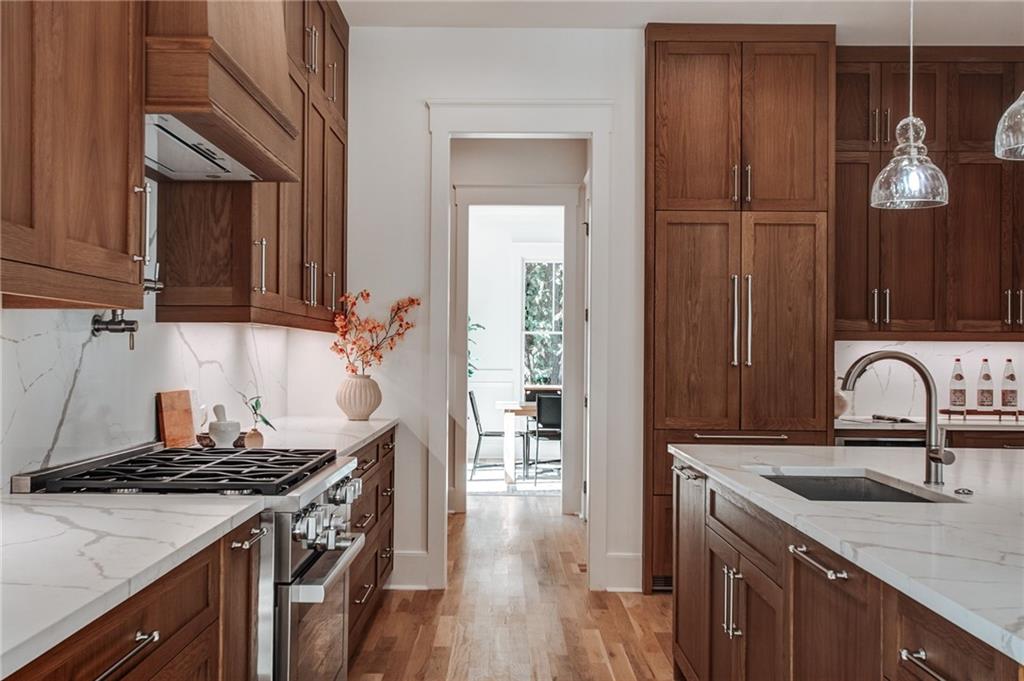 585 Sherwood Road Northeast Atlanta, GA 30324 - Photo 13 of 104 a kitchen with granite countertop a sink stove and cabinets