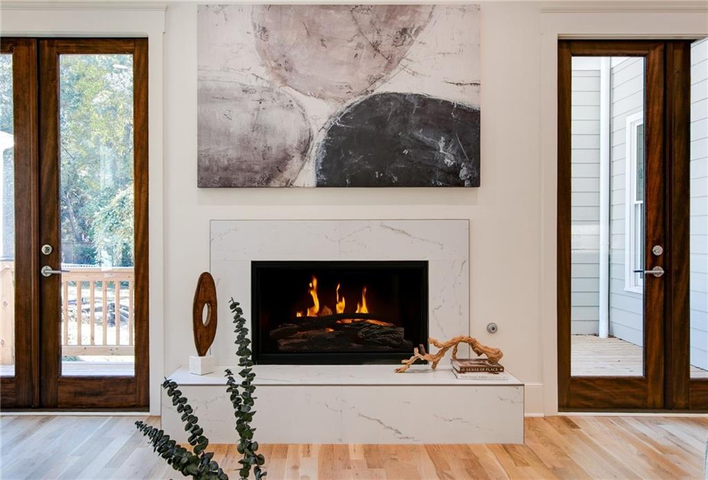 585 Sherwood Road Northeast Atlanta, GA 30324 - Photo 16 of 104 a living room with a fireplace a flat screen tv and a fireplace