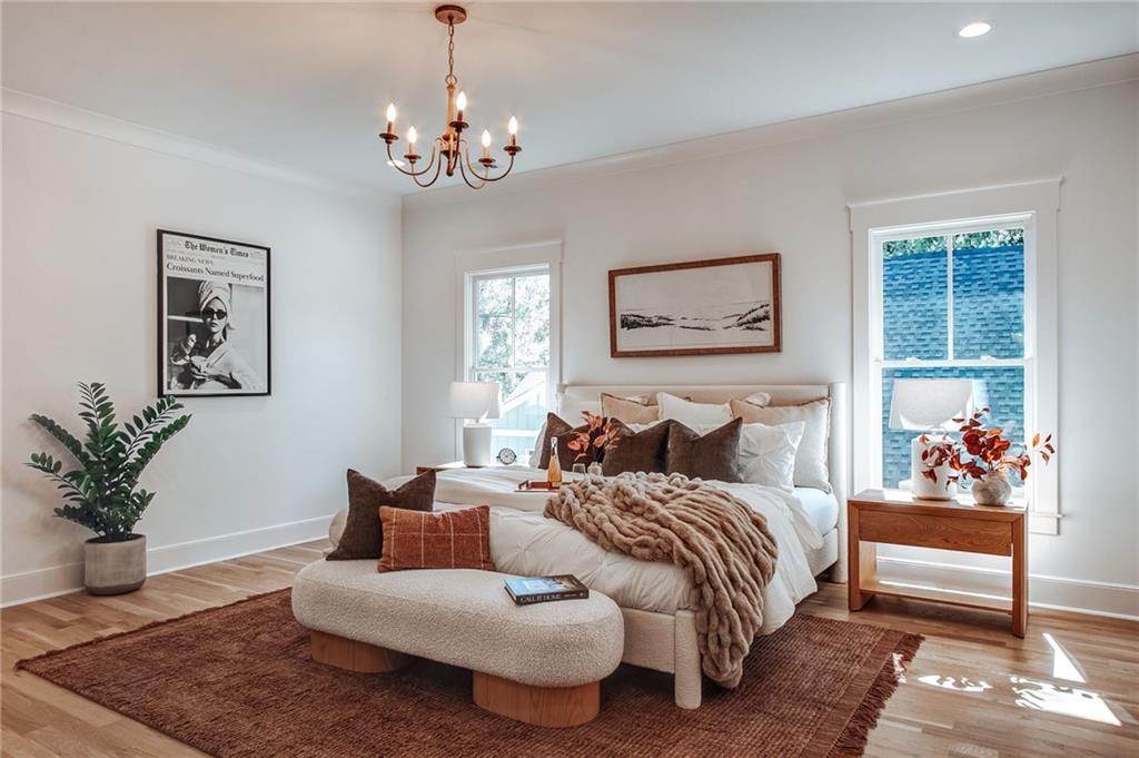 585 Sherwood Road Northeast Atlanta, GA 30324 - Photo 19 of 104 a bedroom with bed and wooden floor
