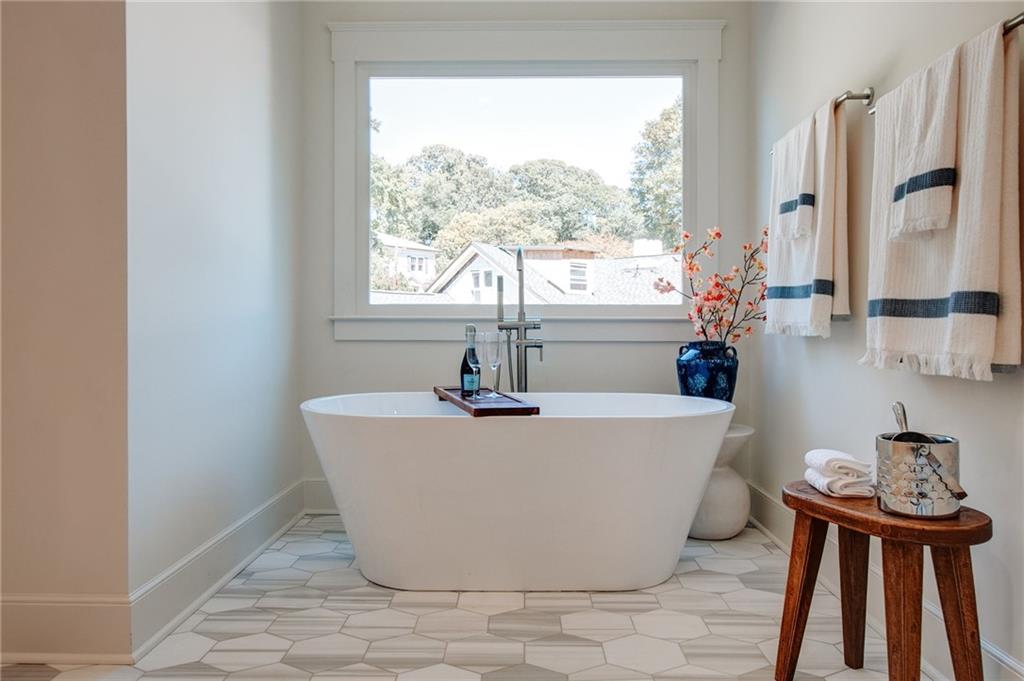 585 Sherwood Road Northeast Atlanta, GA 30324 - Photo 28 of 104 a white bath tub sitting in a bathroom next to a window