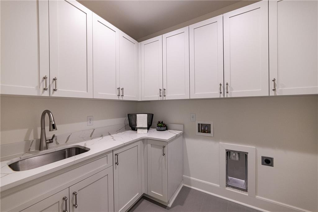 585 Sherwood Road Northeast Atlanta, GA 30324 - Photo 31 of 104 a kitchen with stainless steel appliances granite countertop white cabinets sink and dishwasher