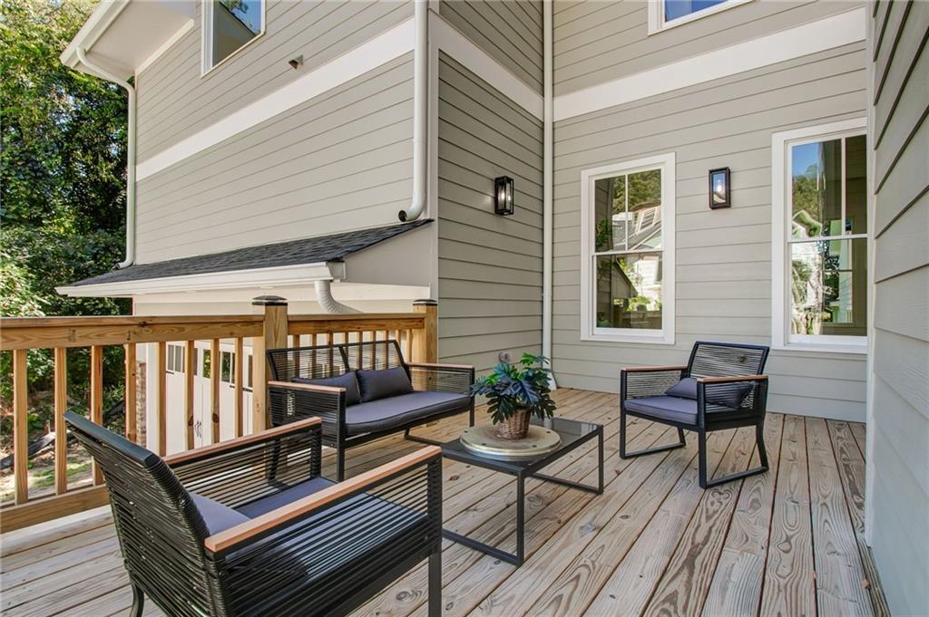 585 Sherwood Road Northeast Atlanta, GA 30324 - Photo 5 of 104 a roof deck with a potted plant and wooden floor