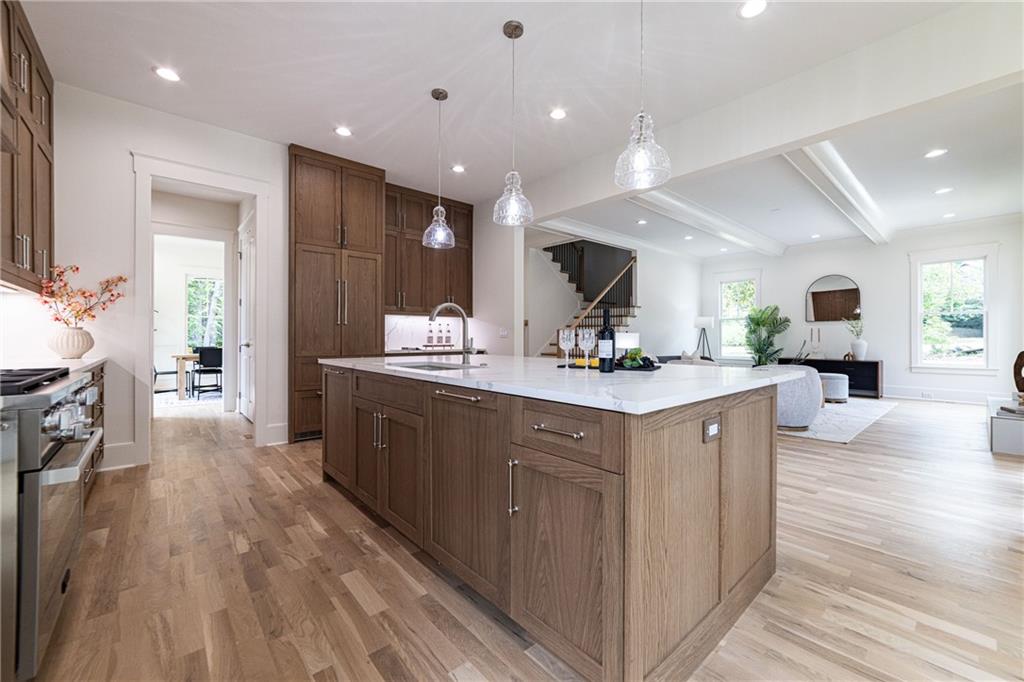 585 Sherwood Road Northeast Atlanta, GA 30324 - Photo 56 of 104 a large kitchen with stainless steel appliances a large counter top a sink and a refrigerator