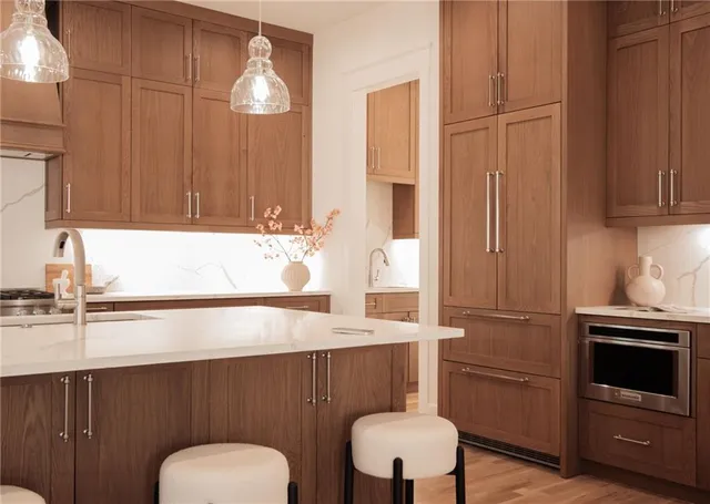 a kitchen with granite countertop a sink stove and cabinets