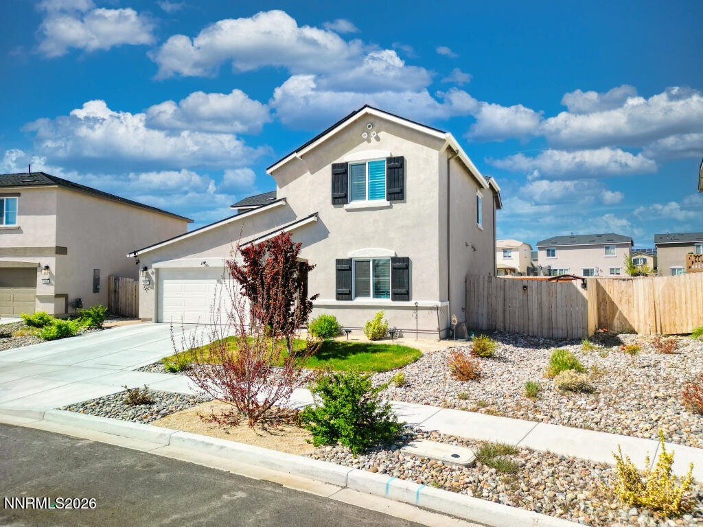 8957 Buffalo Grove Drive Reno, NV 89506 - Photo 3 of 59 a front view of a house with a yard
