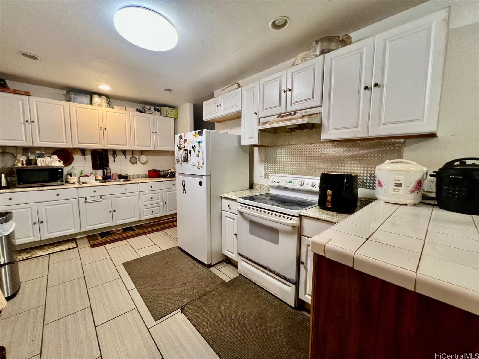 87-159 Maipela Street Waianae, HI 96792 - Photo 7 of 9 a kitchen with cabinets and appliances