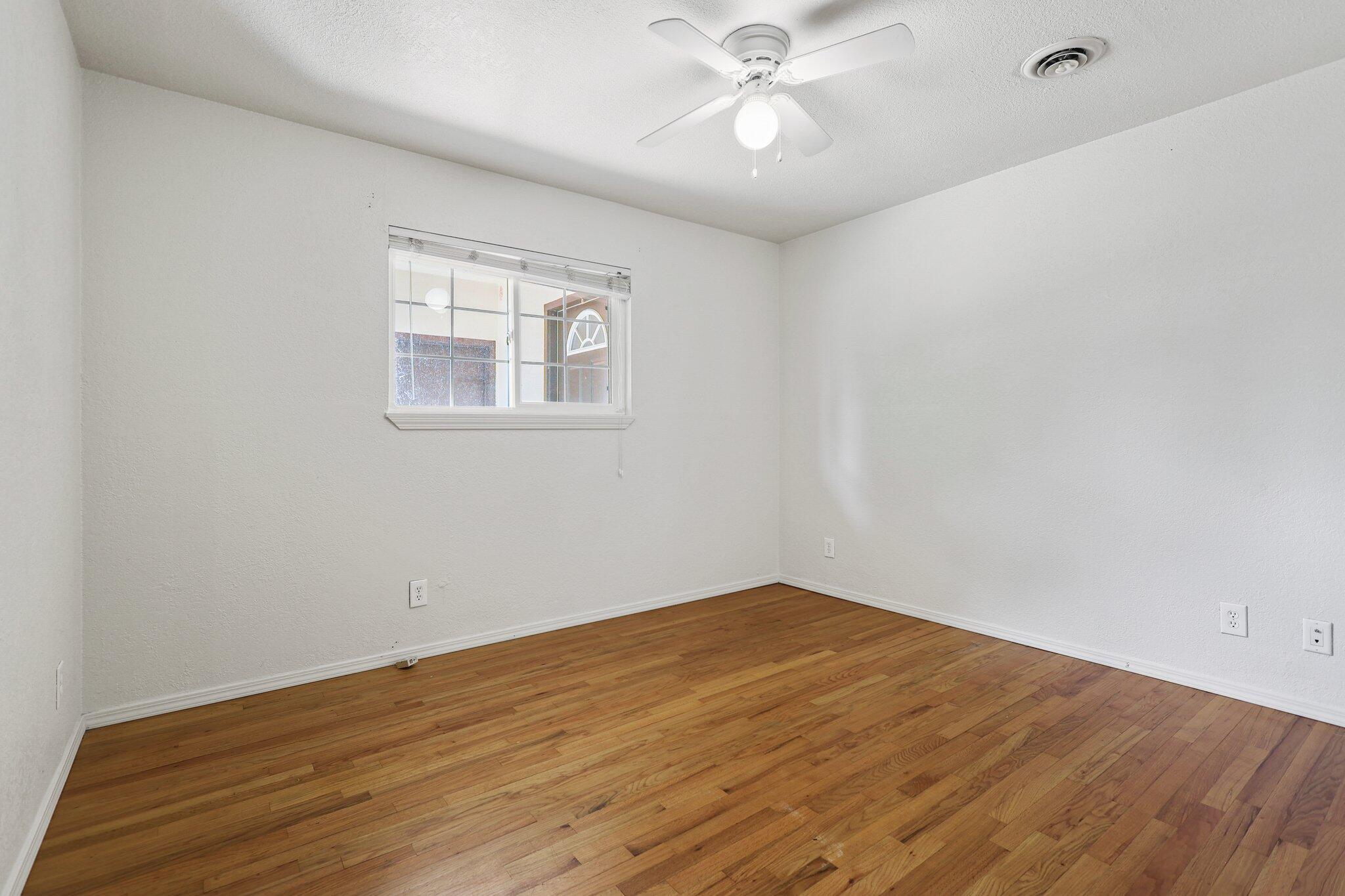 3581 Echo Road Redding, CA 96002 - Photo 11 of 19 a view of an empty room with wooden floor and a ceiling fan