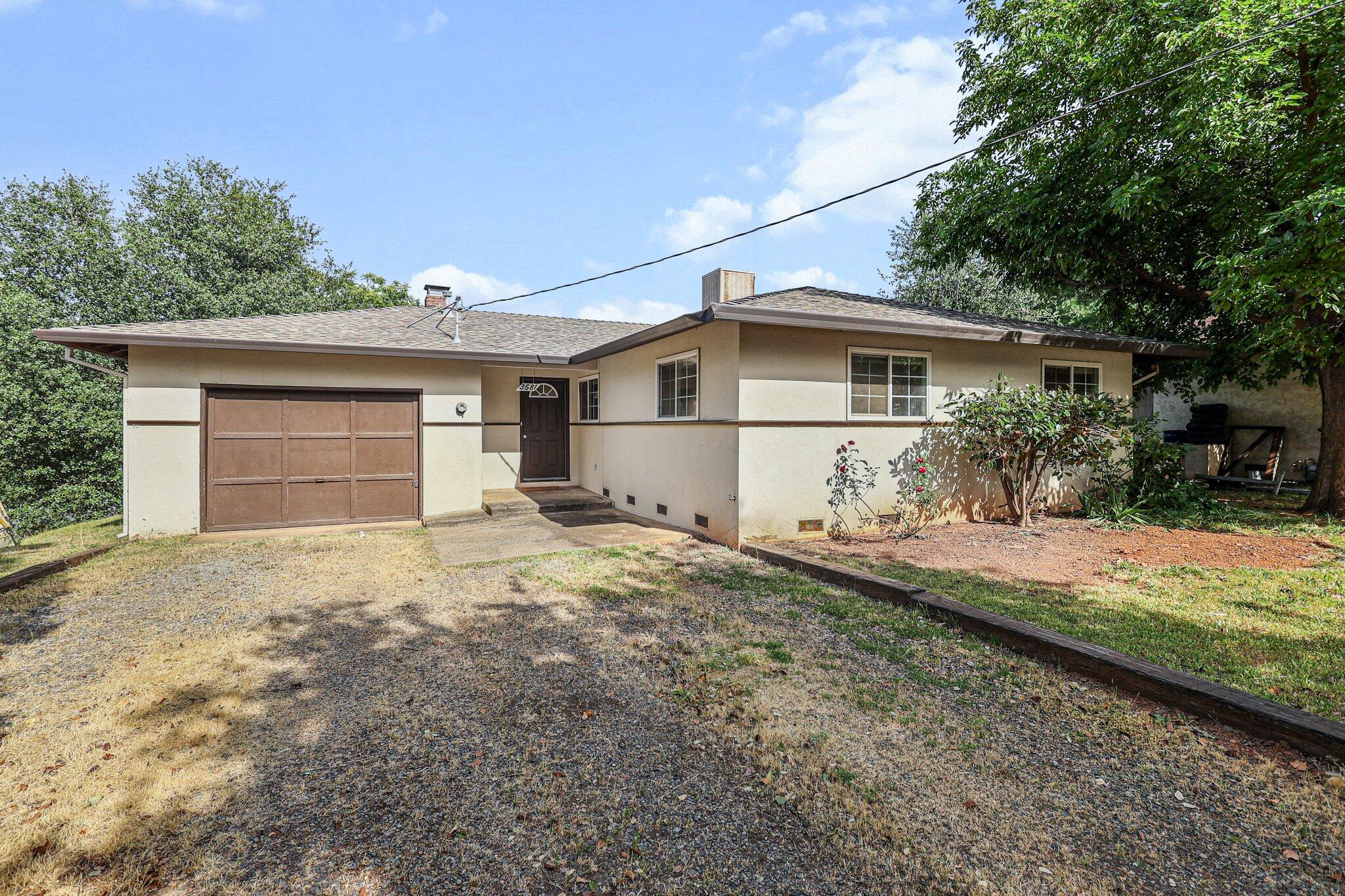 3581 Echo Road Redding, CA 96002 - Photo 17 of 19 a front view of a house with a yard and garage