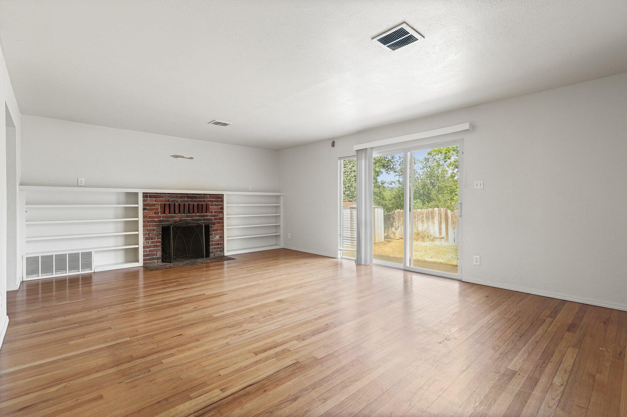 3581 Echo Road Redding, CA 96002 - Photo 2 of 19 wooden floor fireplace and natural light in room