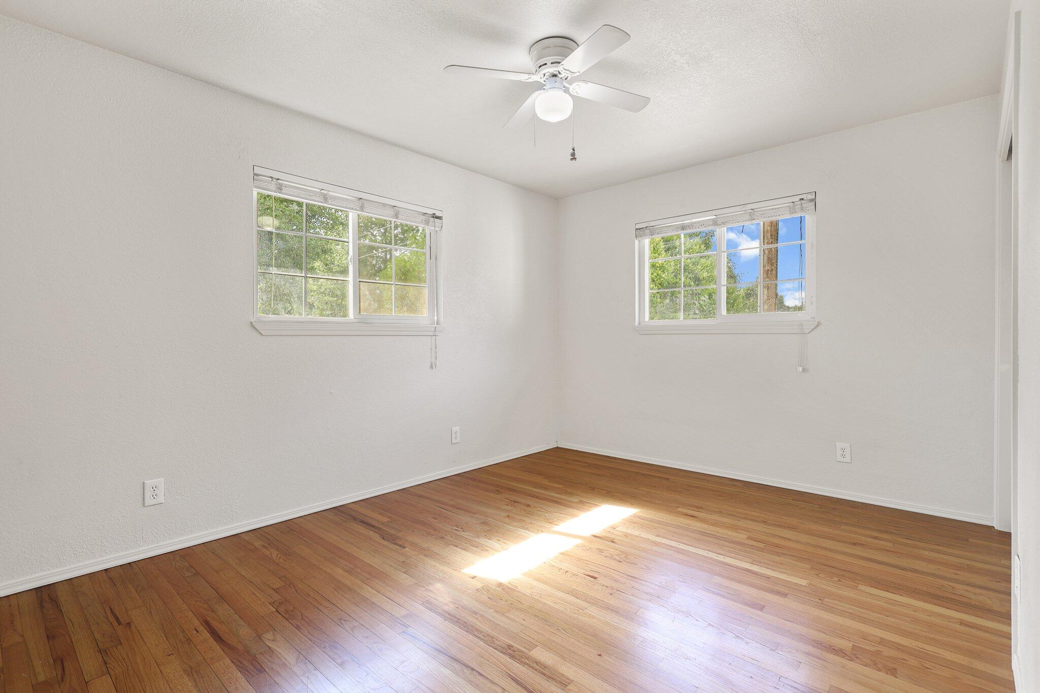 3581 Echo Road Redding, CA 96002 - Photo 8 of 19 a view of empty room with wooden floor and fan
