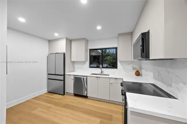 a view of a hallway with washer and dryer